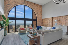 Split Level Pentouse with Floor to Ceiling Arched Window and Panoramic View of the Coast